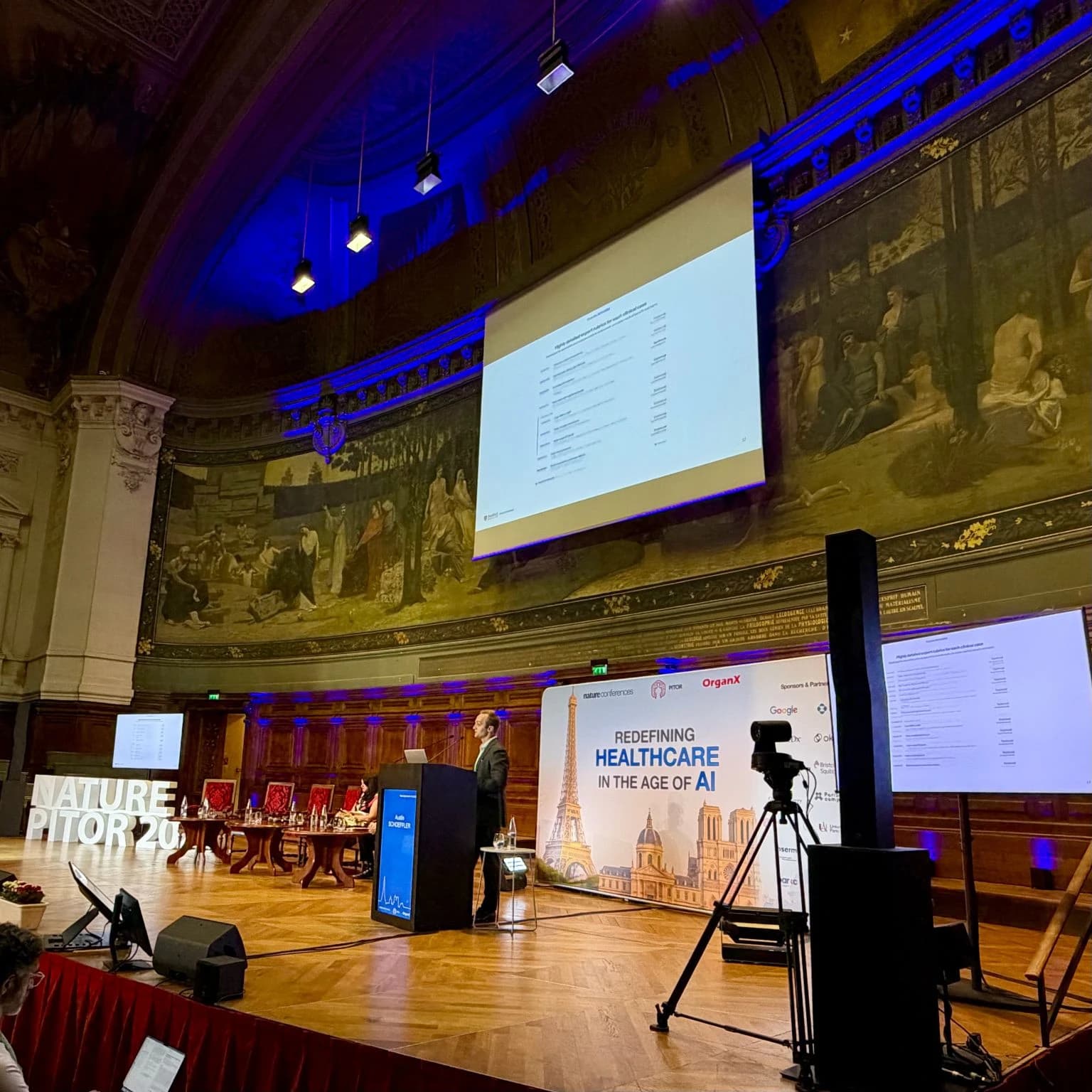 Austin Schoeffler presenting at the podium at the Nature Conferences meeting in Paris